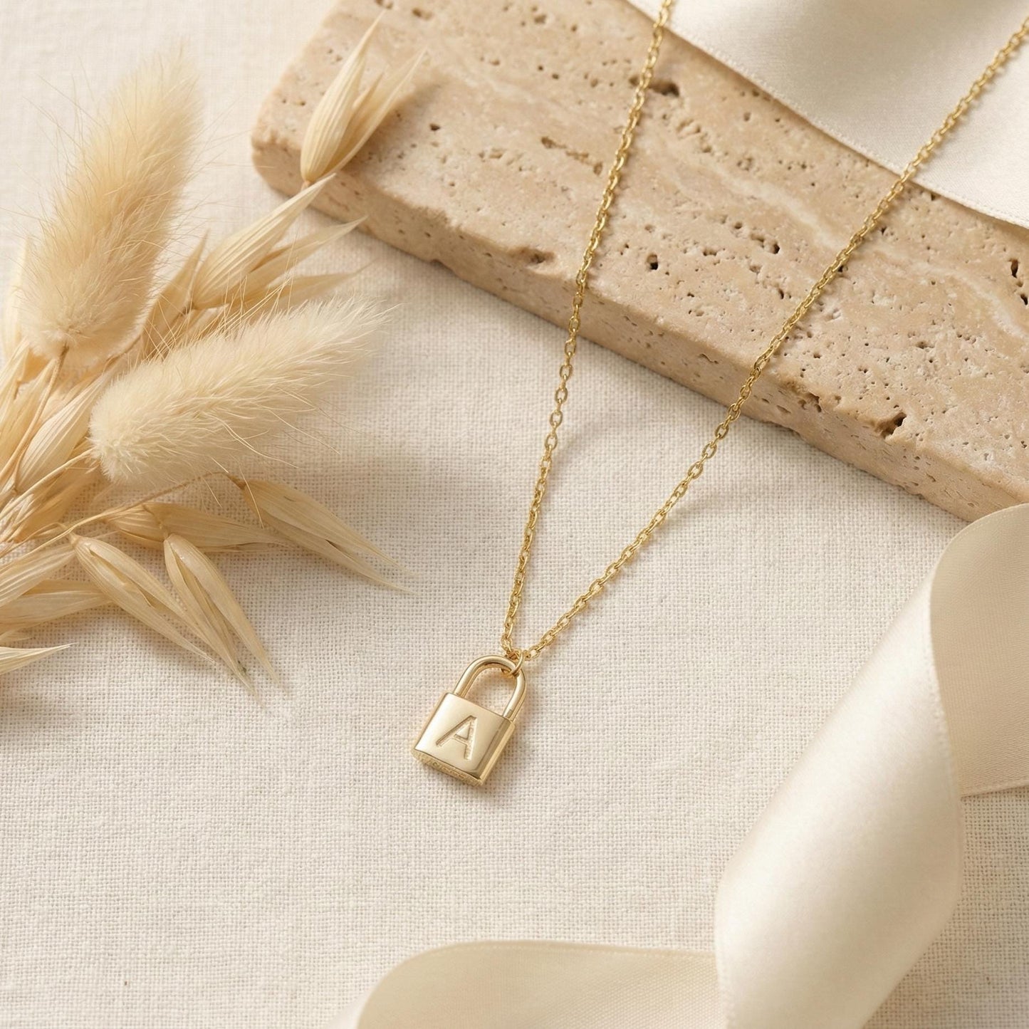 Gold padlock necklace with engraved initial letter A, dainty minimalist personalized jewelry gift for her, Mother's Day custom pendant on model.