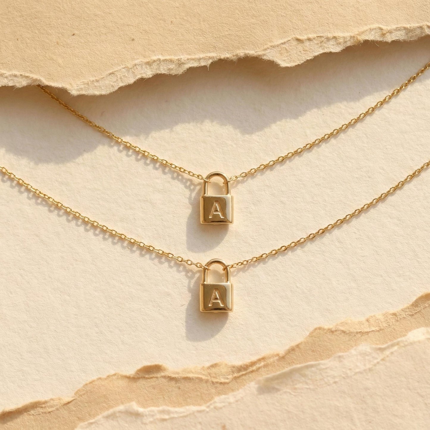 Gold padlock necklace with engraved initial letter A, dainty minimalist personalized jewelry gift for her, Mother's Day custom pendant on model.