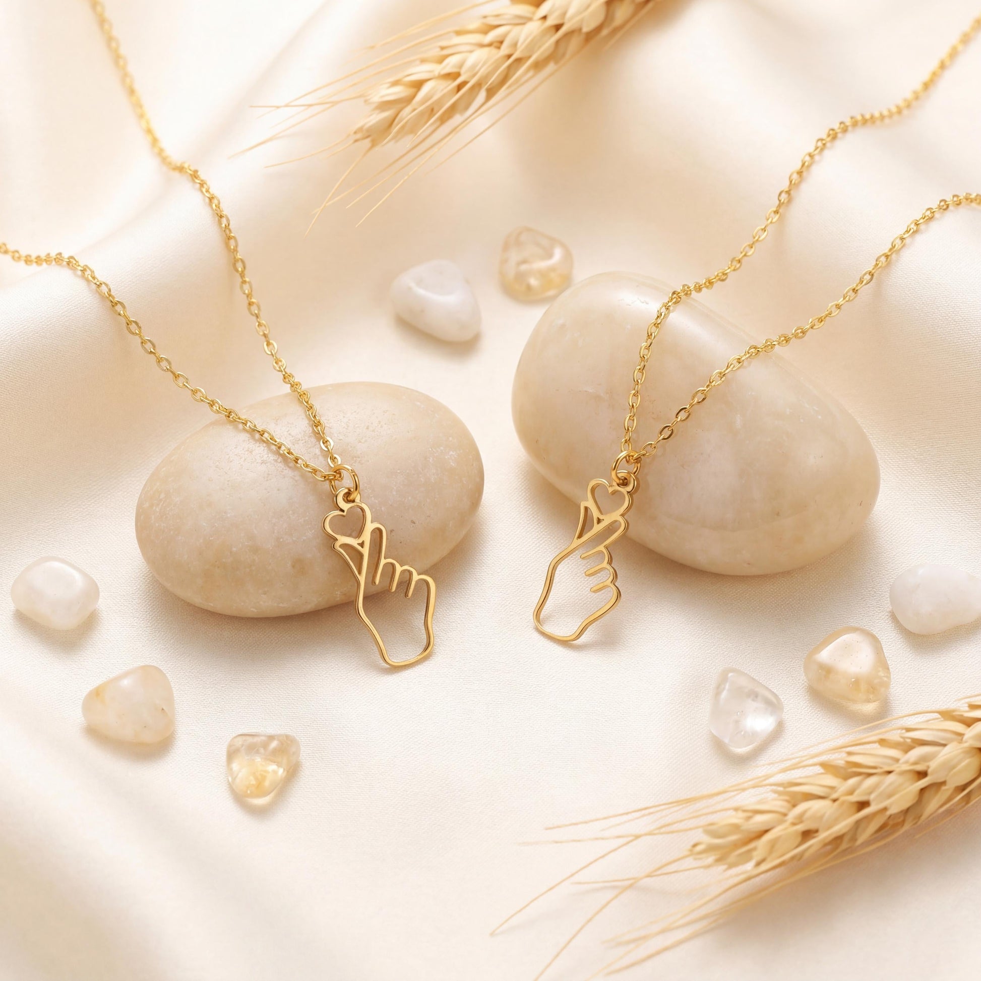 A woman wearing a dainty 14K gold minimalist Korean finger heart necklace, a delicate saranghae hand gesture pendant resting on her collarbone.