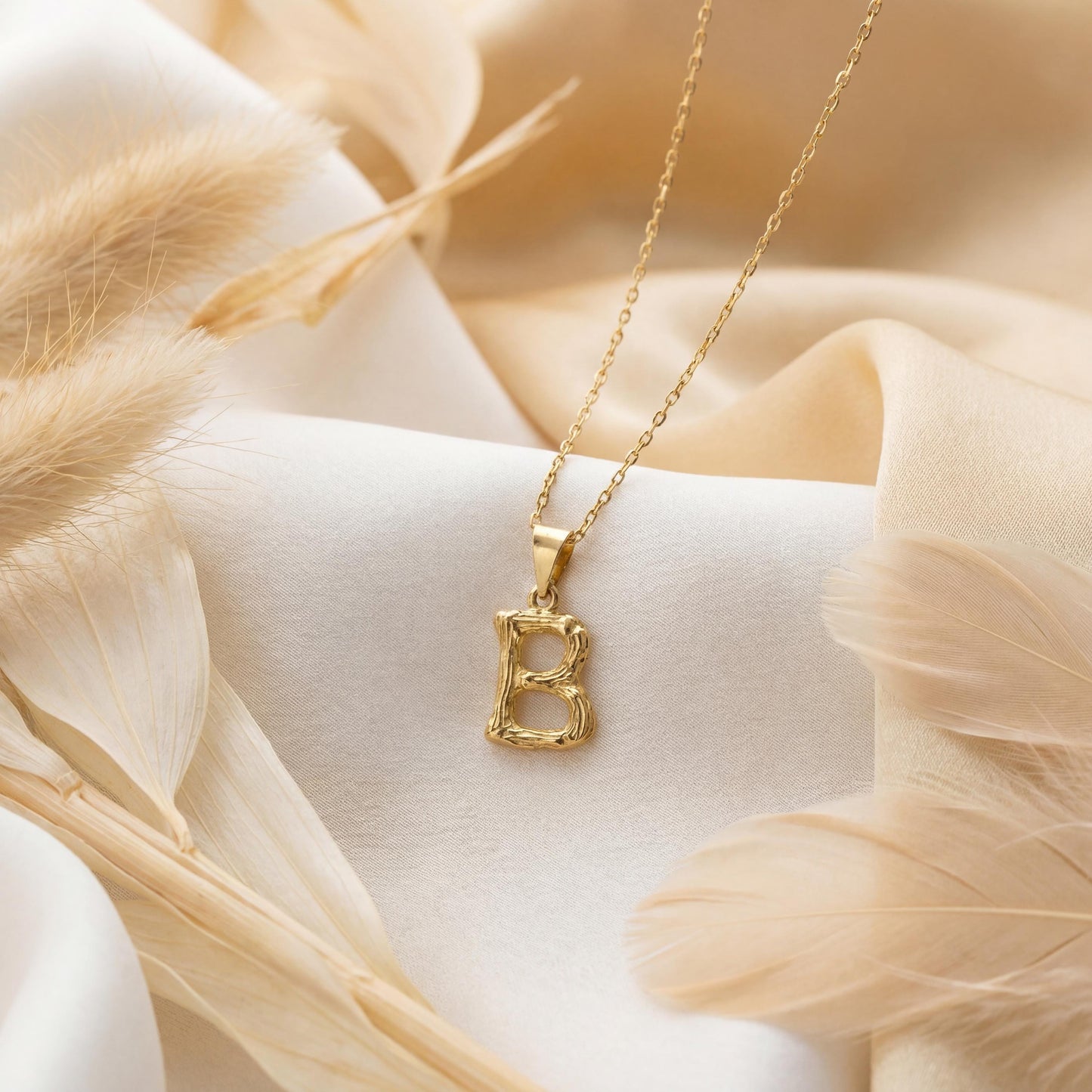 Gold color bamboo texture initial necklace letter pendant on model, minimalist personalized jewelry for mothers day gift.
