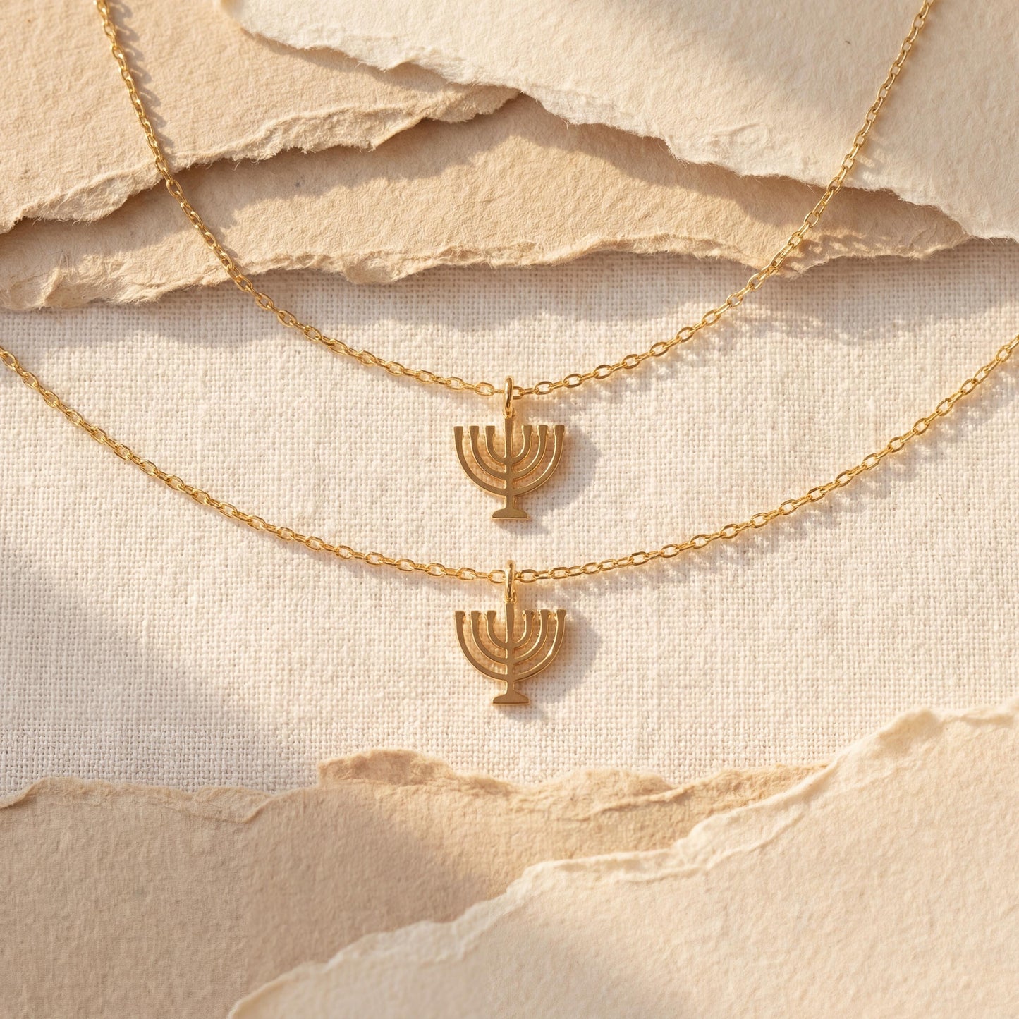 Dainty 14K gold plated minimalist Menorah necklace worn by a woman, elegant Jewish Judaica pendant jewelry ideal for Mother's Day or Bat Mitzvah gift.
