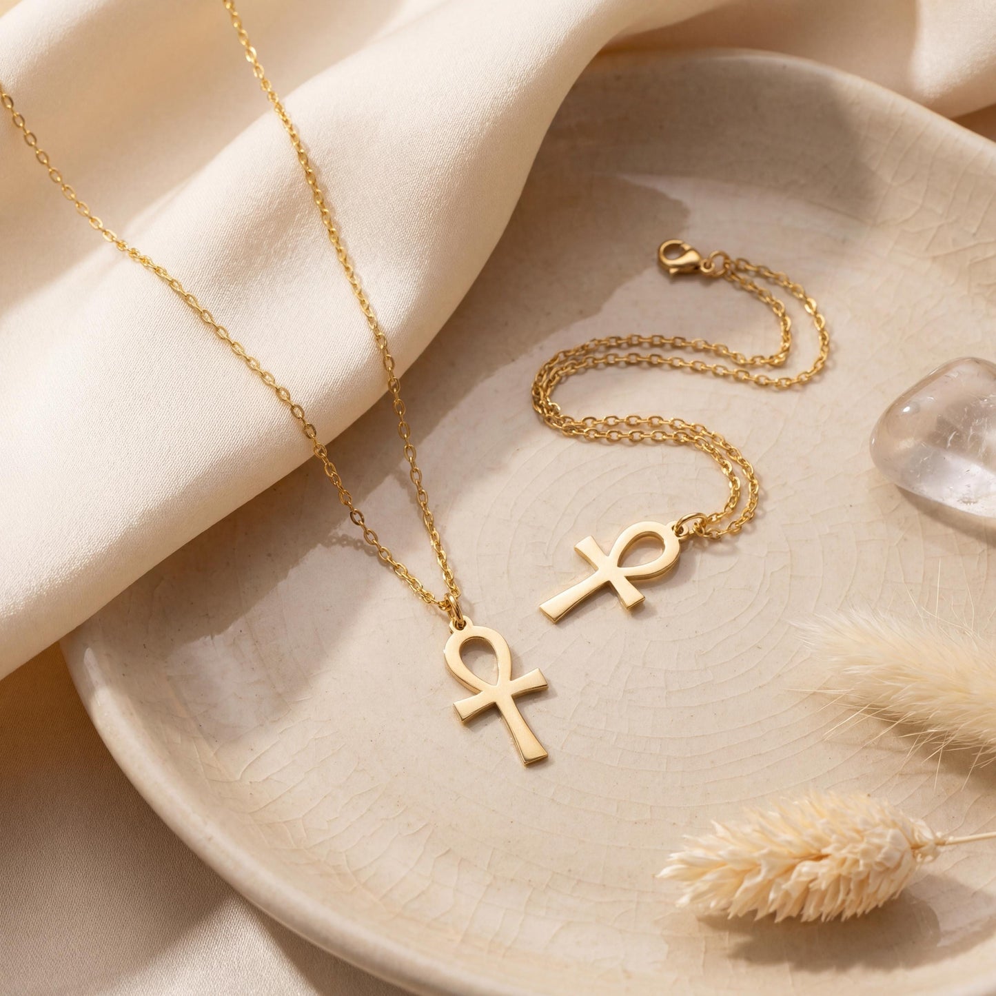 Minimalist Ankh necklace worn by a woman, dainty Egyptian cross key of life pendant resting on chest in natural sunlight, elegant everyday jewelry.