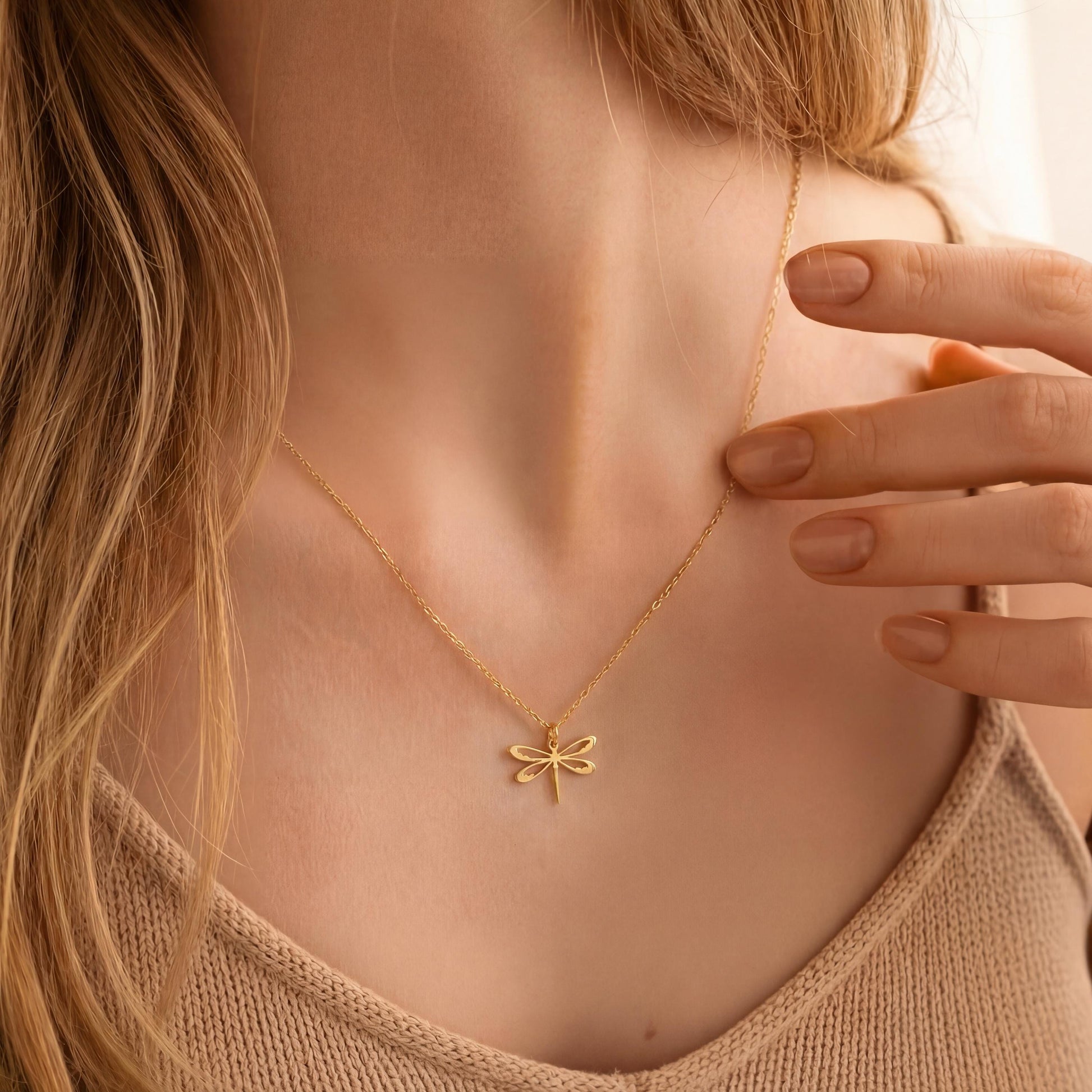 Minimalist 14K gold plated dragonfly necklace worn by a blonde woman, delicate insect pendant resting on collarbone, elegant Mother's Day jewelry gift idea.